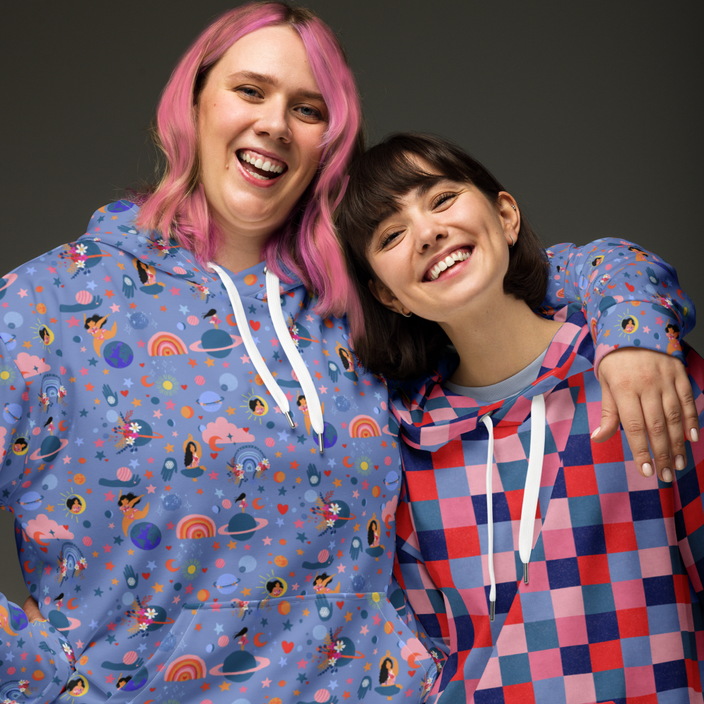 Two people wearing colorful hoodies with a dark background