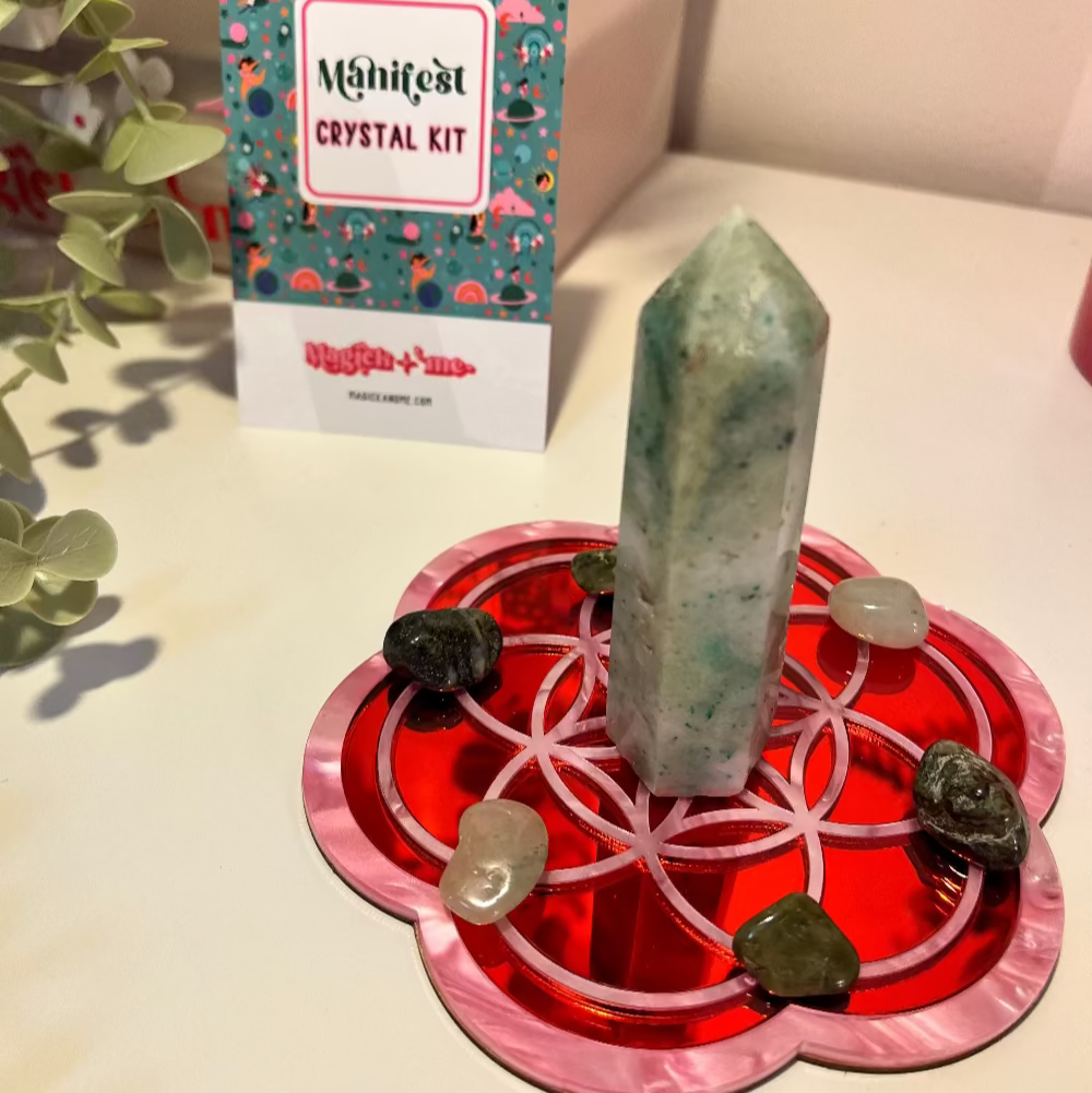 Crystal kit with a green crystal on a red stand, branded 'Manifest'.